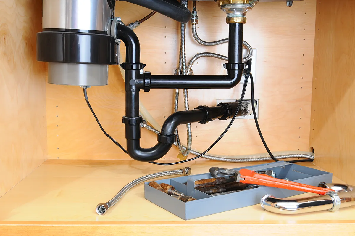 Garbage disposal grinding but not draining in Wesley Chapel with P-trap and drain pipes under kitchen sink.